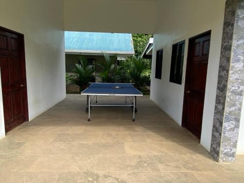 a ping pong table sitting in the middle of a courtyard at Drake Bay River View in Drake