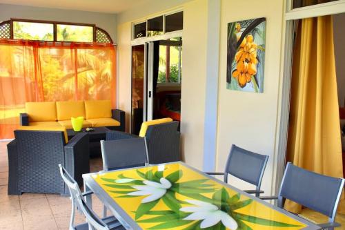 a dining room with a table and chairs at Tekauhivai Lodge in Uturoa