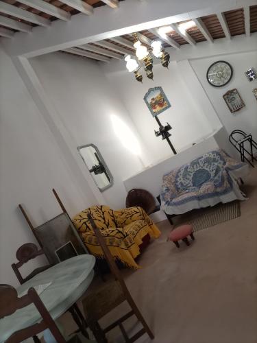 a bedroom with a bed and a table and chairs at O Mundo da Lua in Azeitao