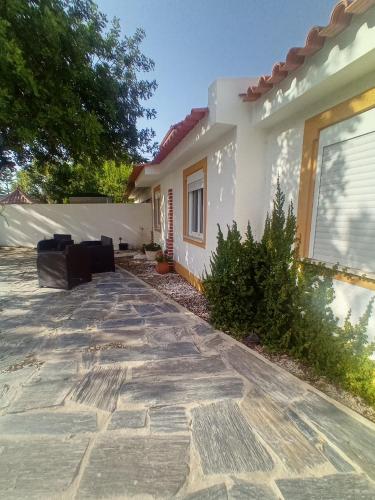 a house with a stone walkway in front of it at O Mundo da Lua in Azeitao