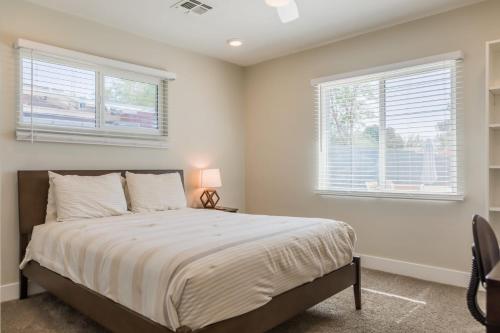 a bedroom with a bed and two windows at Modern Arcadia Lite Oasis Pool Heater BBQ in Phoenix