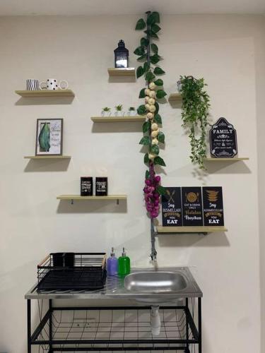 a bathroom with a sink and shelves on a wall at Tanjung Hijau Homestay - FREE wifi - 2ndFloor - 4 bedrooms in Rawang