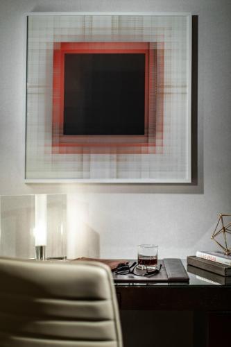 a living room with a television and a table with a glass at Red Rock Casino Resort & Spa in Las Vegas