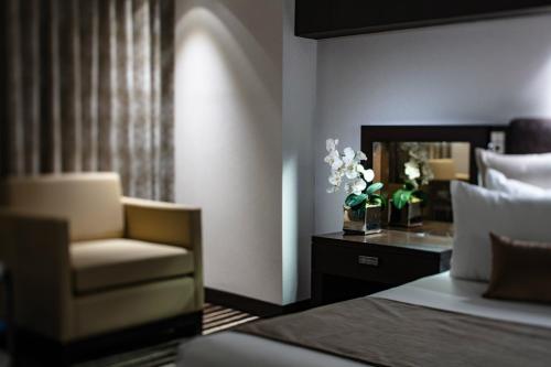 a bedroom with a bed and a chair and a mirror at Red Rock Casino Resort & Spa in Las Vegas