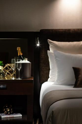 a bedroom with a bed and a table with wine glasses at Red Rock Casino Resort & Spa in Las Vegas