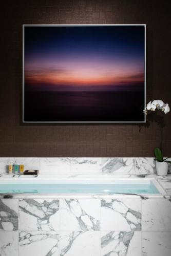 a television hanging above a tub in a bathroom at Red Rock Casino Resort & Spa in Las Vegas