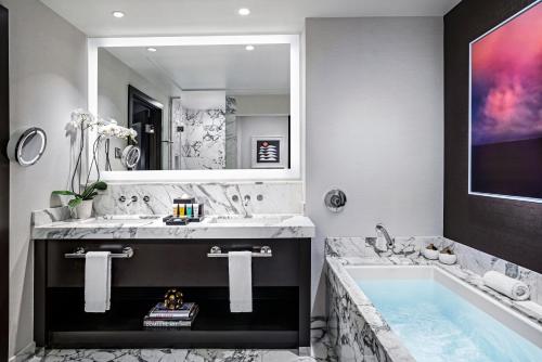 a bathroom with a large tub and a large mirror at Red Rock Casino Resort & Spa in Las Vegas