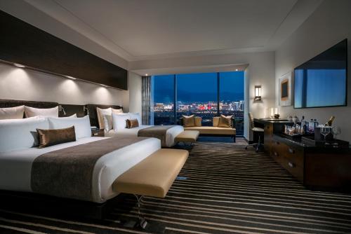 a hotel room with a large bed and a large window at Red Rock Casino Resort & Spa in Las Vegas