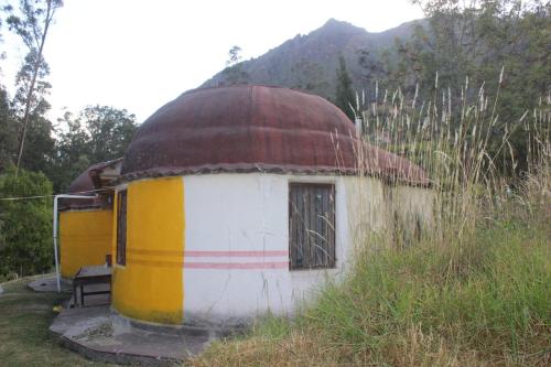 a round building with a dome on top of a field at Albergue Esmeralda - Camping in Sorata