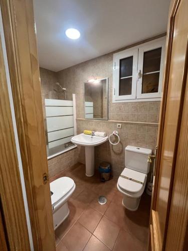 a bathroom with a toilet and a sink at BUENAVISTA DELUXE in Sierra Nevada