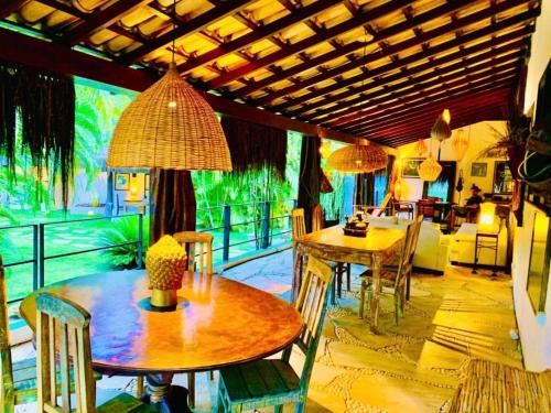 a living room with two tables and a couch at Pousada Terra do Mar in Búzios