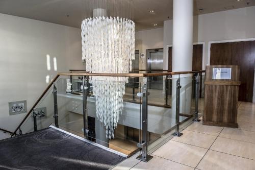 a lobby with a table and a chandelier at Holiday Inn Express Manchester City Centre by IHG in Manchester
