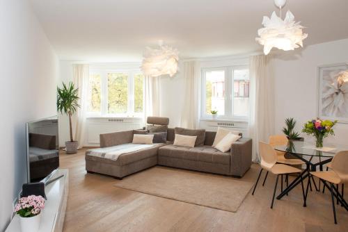 a living room with a couch and a table at Luxury Apartment Res in Ljubljana