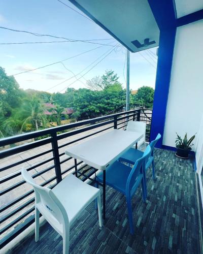 a table and chairs on a balcony with a view at Charlotte's Vacation Home Busuanga Palawan in Buluang