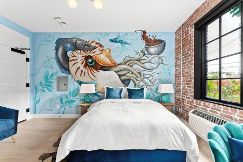a bedroom with a whale mural on the wall at The Acoma House in Denver