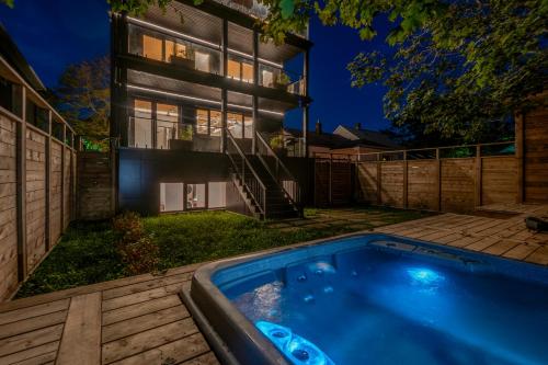 a swimming pool in front of a house at night at Sunrise View - Spa-Inspired Guestroom, Halifax Rooftop Home in Halifax