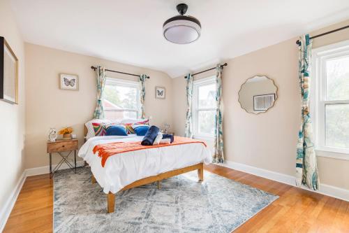 a bedroom with a bed and two windows at Classic Brick House 4BR 3BA Perfect for Families Near DC in Arlington