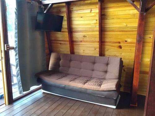 a couch sitting in the corner of a room at Villas Margarita, Mazamitla, Jalisco. in Mazamitla