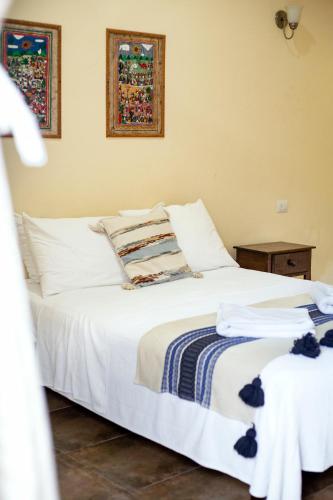 a bedroom with a white bed with towels on it at hotel stella maris tulum in Tulum