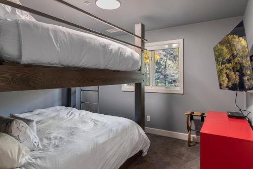 a bedroom with two bunk beds and a window at Outlaws Creek in Telluride