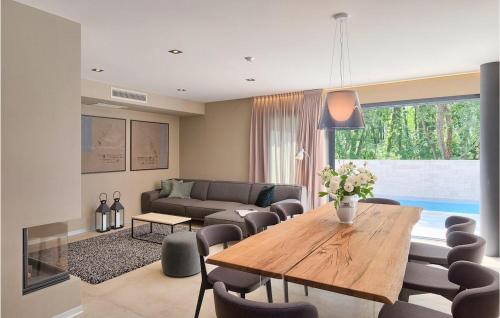 a living room with a wooden table and chairs at Villa Oliva 1 in Umag