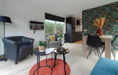 a living room with two chairs and a table at 2 Bedroom Awesome Home In Heinkenszand in Heinkensand