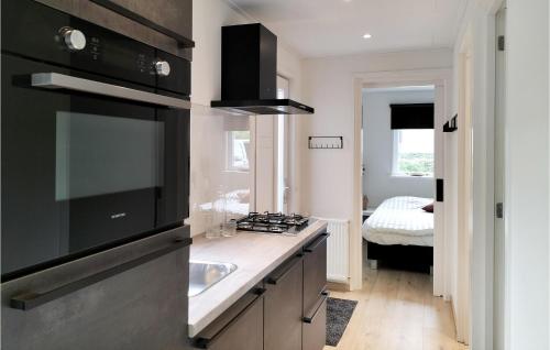 a kitchen with a sink and a stove at 2 Bedroom Awesome Home In Heinkenszand in Heinkensand