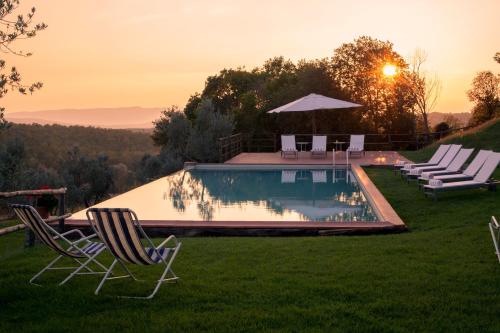 a lawn chair sitting in front of a pool of water at Borgo Sant'Ambrogio - Resort in Pienza