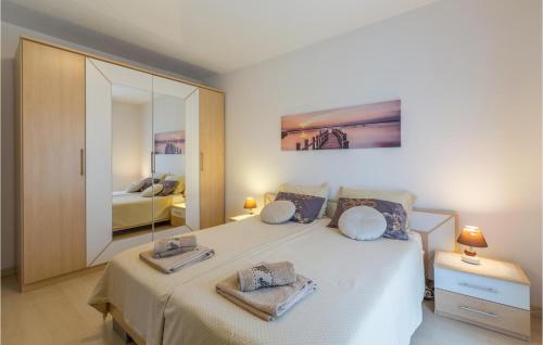 a bedroom with a bed with two towels on it at Stunning Home In Porec With Wifi in Poreč