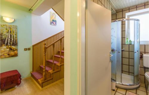 a bathroom with a shower and a staircase at Stunning Home In Porec With Wifi in Poreč