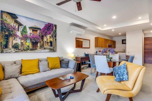 a living room with a couch and a table at A FEW BREEZY STEPS TO THE BEACH ~LUXURIOUS STAY~ in Puerto Vallarta