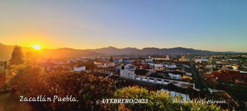 a view of a city at sunset at HOSPEDAJE 4Casa San Francisco in Zacatlán
