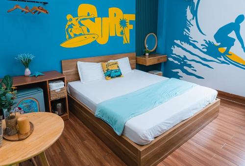 a bedroom with a bed and a table in it at Blossom Sea Homestay Quy Nhơn in Quy Nhon