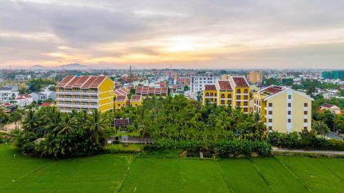 a view of a city with palm trees and buildings at La Siesta Hoi An Resort & Spa in Hoi An