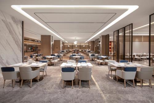 a restaurant with tables and chairs in a room at Crowne Plaza Shanghai Jinxiu, an IHG Hotel in Shanghai