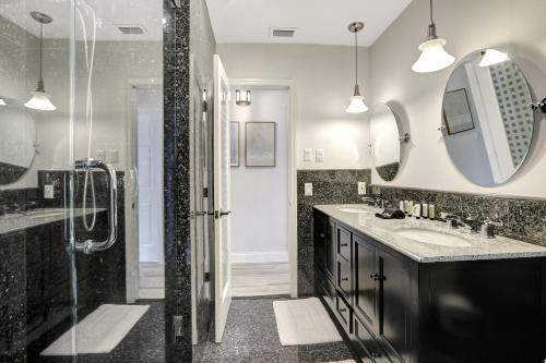 a bathroom with a shower and a sink and a mirror at Riviera - Canal Views, Pool, & Work Friendly. in Fort Lauderdale