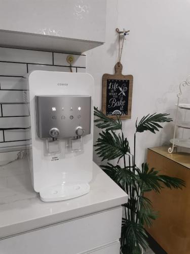 a kitchen with a white mixer on a counter at Venice Raudhah Guest House in Lumut