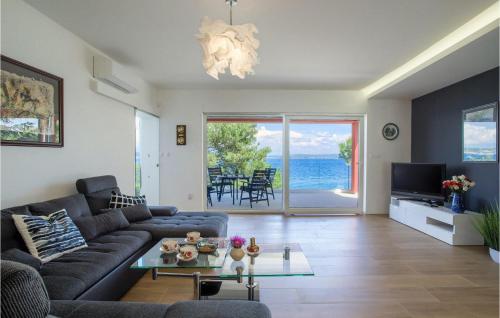 a living room with a couch and a table at Villa Karmen Adriatica in Zadar