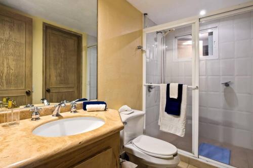 ein Bad mit einem Waschbecken, einem WC und einer Dusche in der Unterkunft Beach Front-Ocean Views-Marina Luxury Condo-BVG in Puerto Vallarta