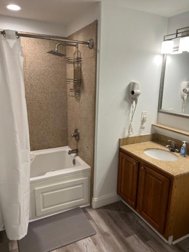 a bathroom with a tub and a sink and a shower at Big Pool, stunning Lakeview, Sunrise, Disney # 710 in Orlando