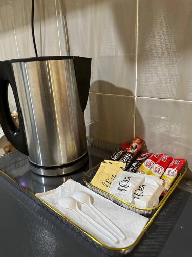 a tray of food on a counter next to a coffee pot at Laguna Raudhah Apartment in Lumut