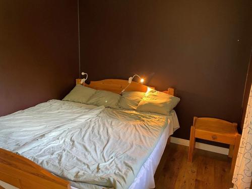 a bedroom with a bed with a light on it at Holiday home SURAHAMMAR in Surahammar