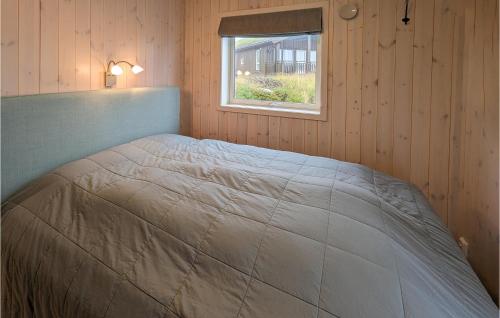 a bed in a room with a window at 4 Bedroom Lovely Home In Lillehammer in Lillehammer