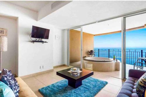 a living room with a view of the ocean at BEACH FRONT~ JACUZZI ~ SPECTACULAR OCEAN VIEWS in Puerto Vallarta