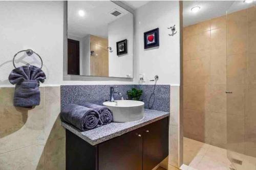 a bathroom with a sink and a mirror at BEACH FRONT~ JACUZZI ~ SPECTACULAR OCEAN VIEWS in Puerto Vallarta