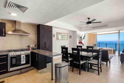 a kitchen and dining room with a view of the ocean at BEACH FRONT~ JACUZZI ~ SPECTACULAR OCEAN VIEWS in Puerto Vallarta