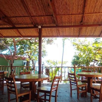 a group of tables and chairs in a restaurant at El Marabu Chill'n Surf in Aposentillo