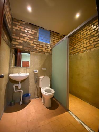a bathroom with a toilet and a sink at Segar Recreation Agro Park in Port Dickson