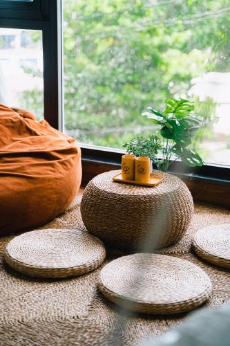 a group of plates sitting on a table next to a window at Blossom Sea Homestay Quy Nhơn in Quy Nhon