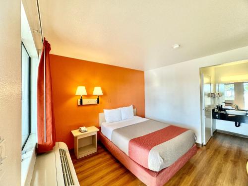 a hotel room with a bed and a bathroom at Motel 6-Bellflower, CA - Los Angeles in Bellflower